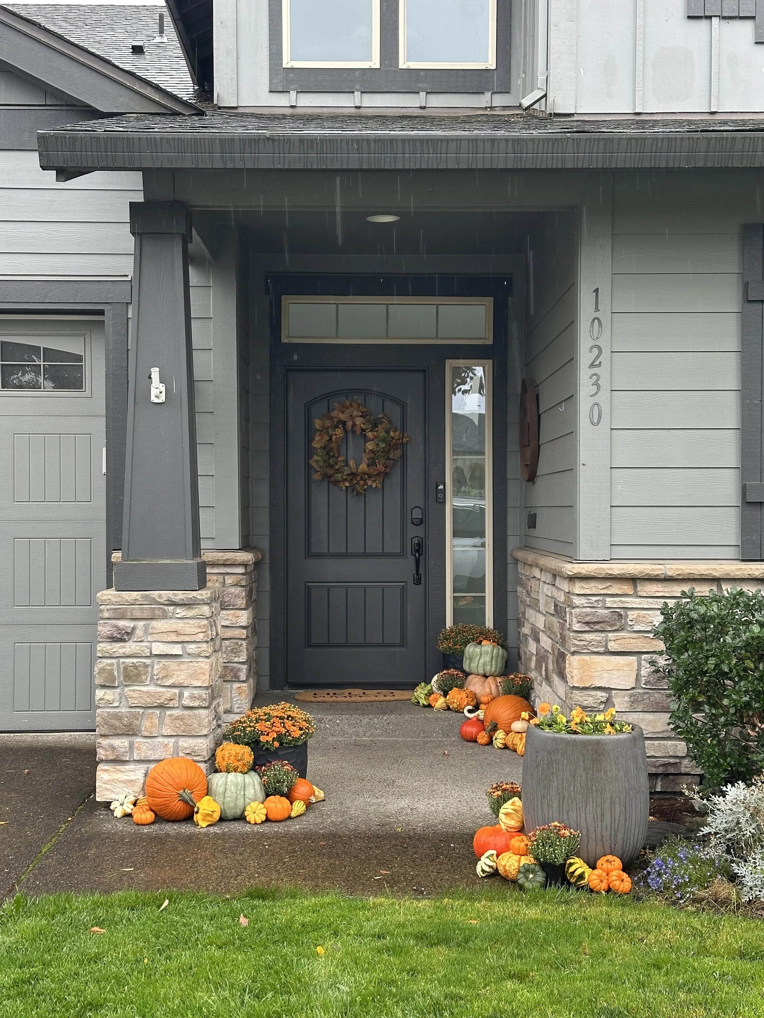 Fall Front Porch with pumpkins and orange mums.