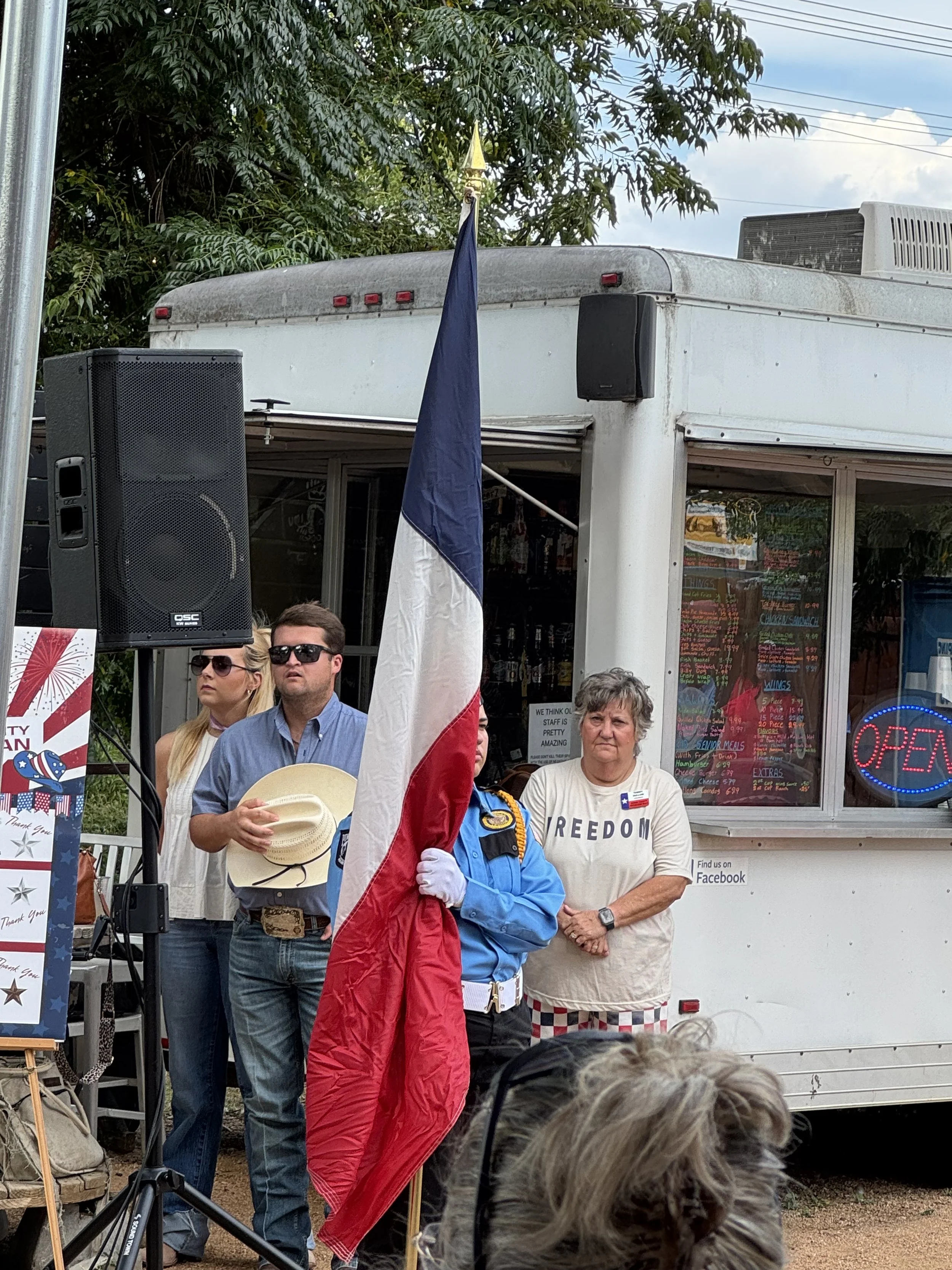 Jordan Killebrew and Burnet County Republican Chair Tammy Hullum stand at attention during the presentation of the US & Texas flags.