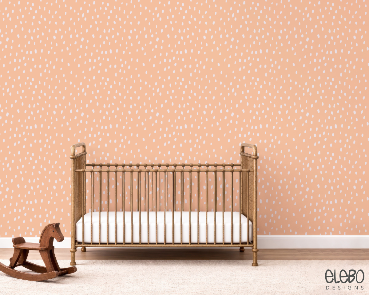 spots-light-peach-and-white-nursery-with-brass-crib.webp