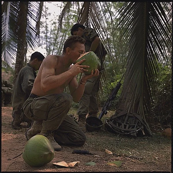 1st Cavalry Division soldier drinking from coconut