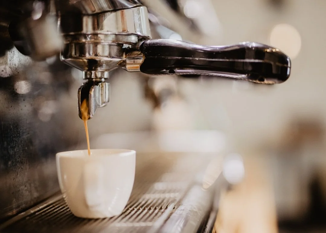 Light roast specialty coffee drink cafe, espresso shot being pulled with machine