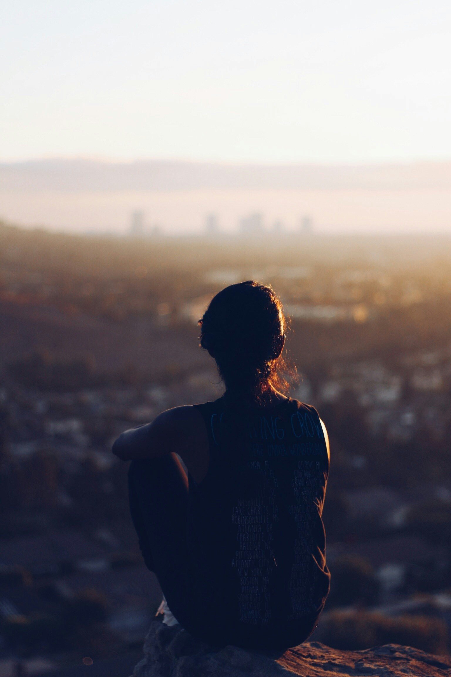 Woman sitting calmly and staring at city views