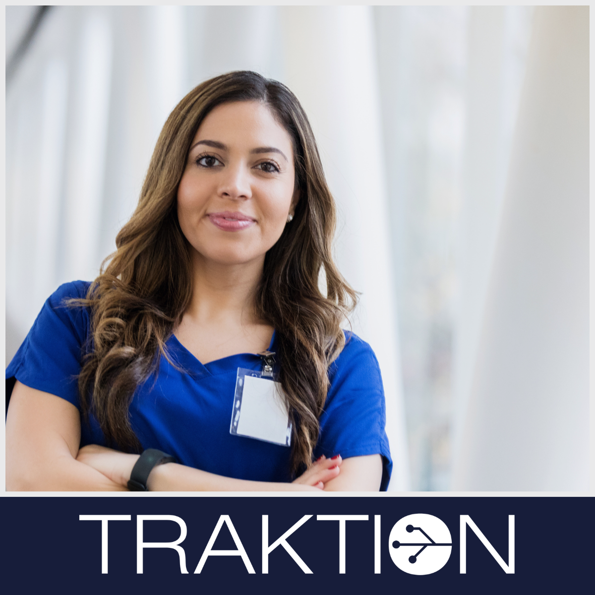 Female clinician smiling at the camera in hospital setting
