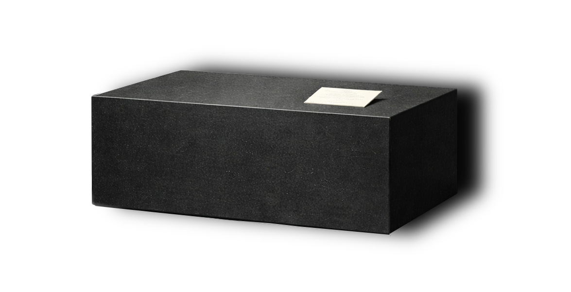 A black rectangular stone museum plinth with an information card about a gallery exhibit.