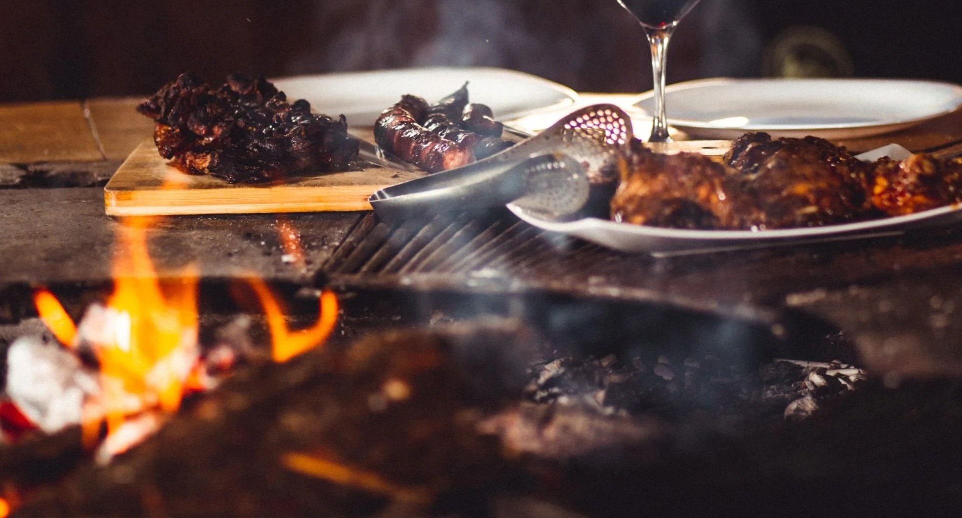 closeup-shot-barbequed-meat-glass-wine-near-fireplace.jpg