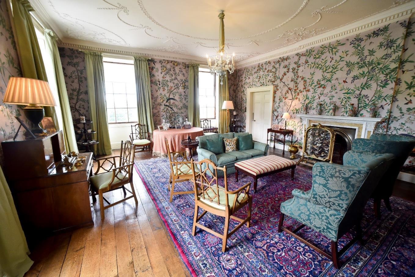 Group of friends at a celebration, smiling and laughing in a cozy indoor setting.