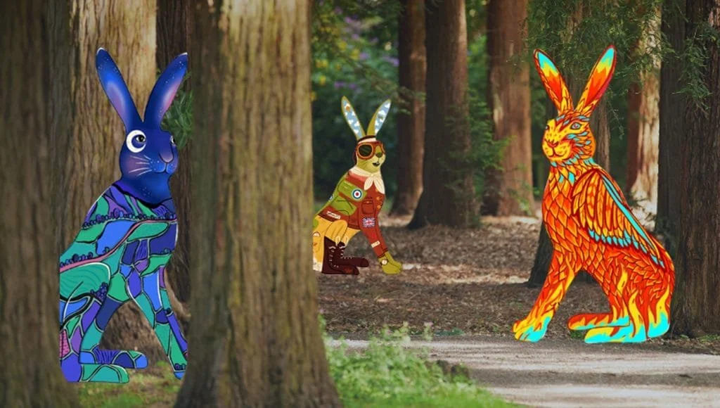 Ruined castle on a hill overlooking the ocean during sunset, with blue flowers in the foreground.