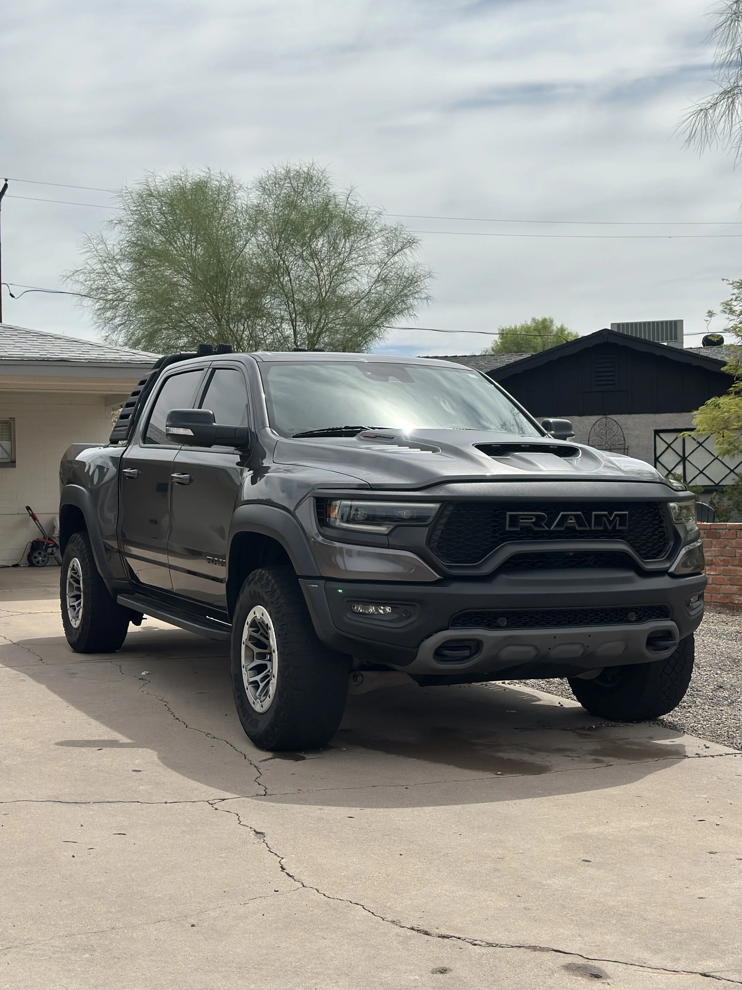 A black RAM pickup truck parked on a driveway.