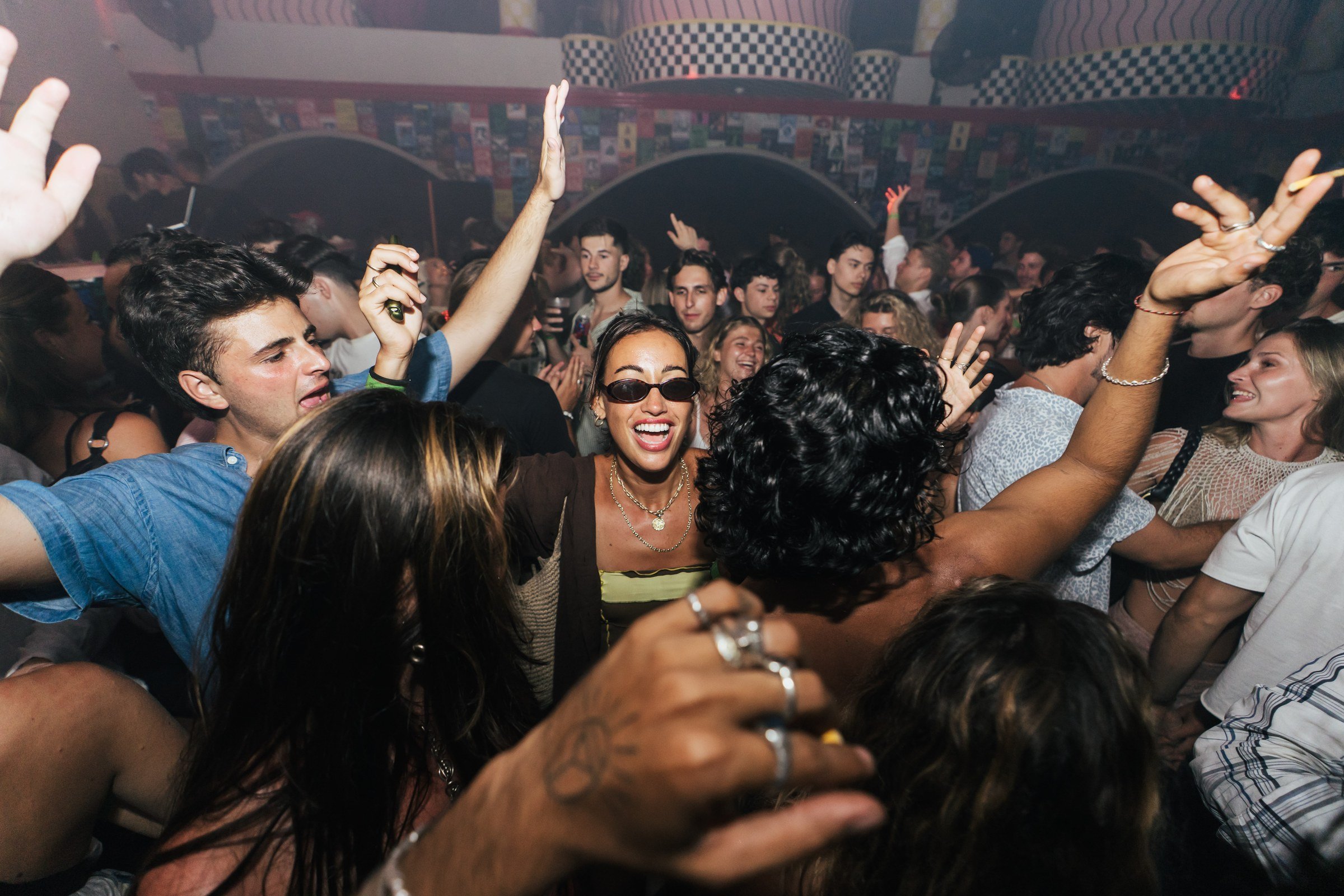 Friends dancing together on the Club Corazón dance floor.