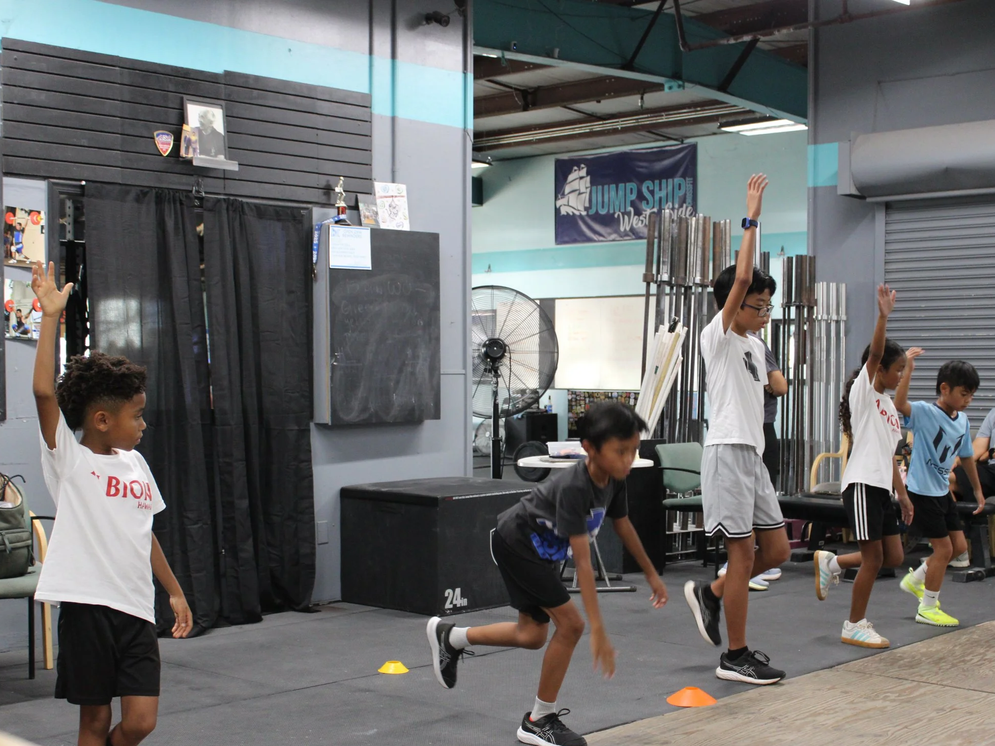 A group of kids doing warm-up exercises
