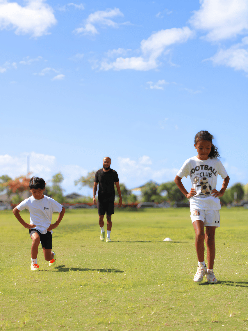 Kids doing lunges and participating in youth performance training program