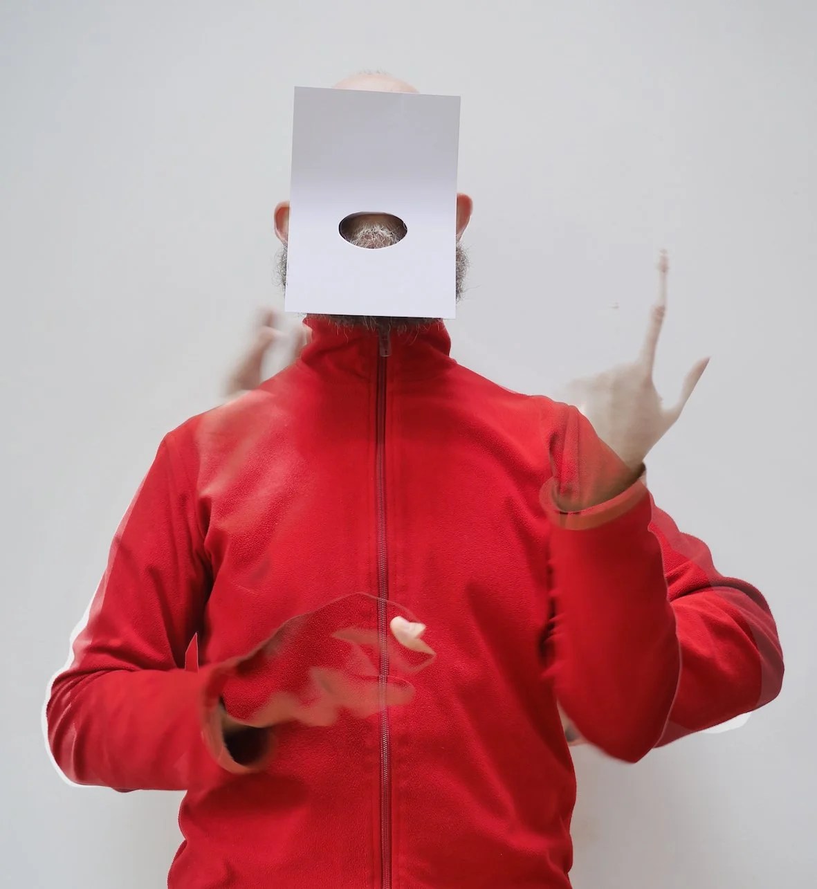 Mark Leahy in a red jacket with a square over his face