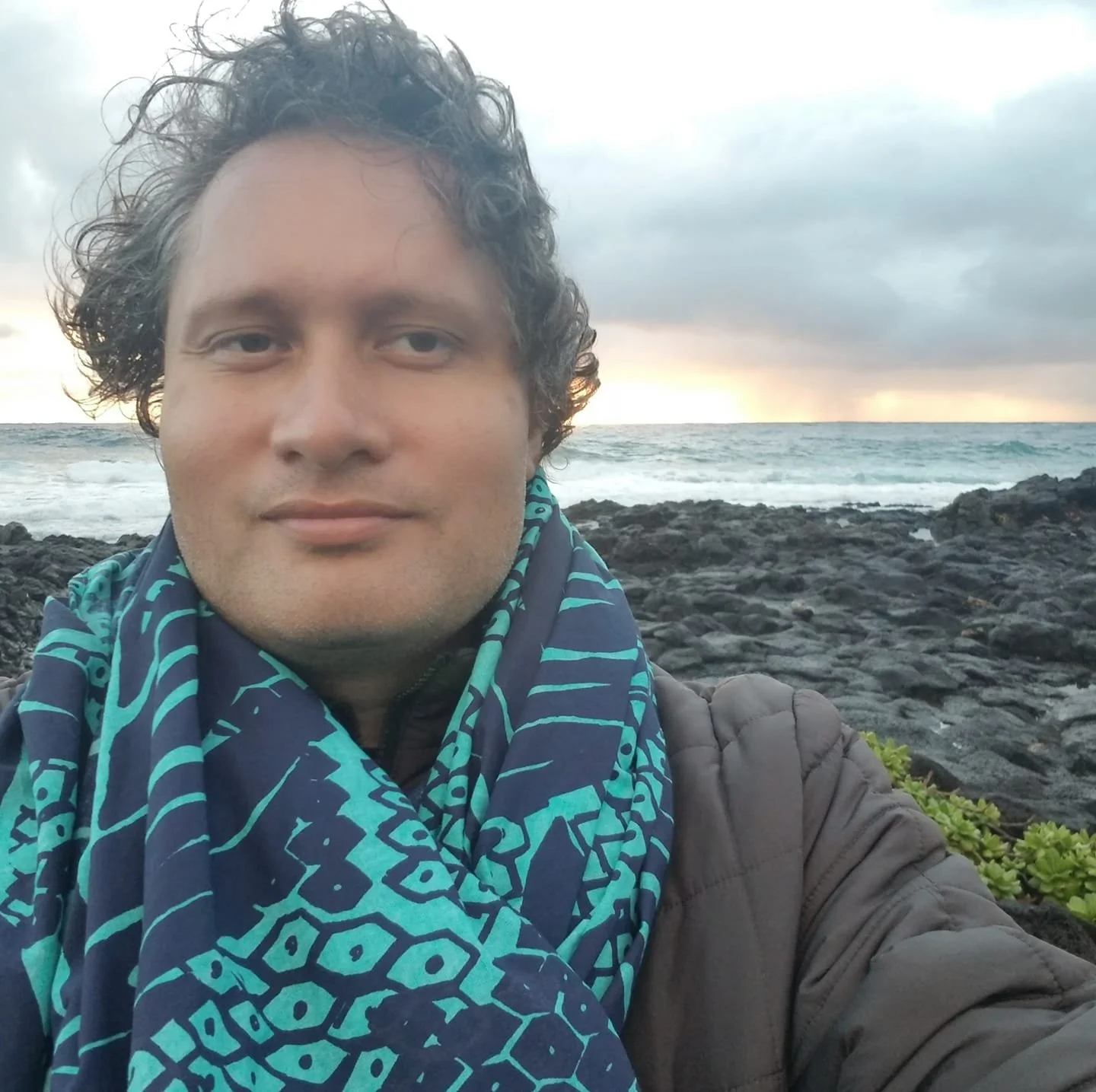 Man taking selfie in front of a beach view