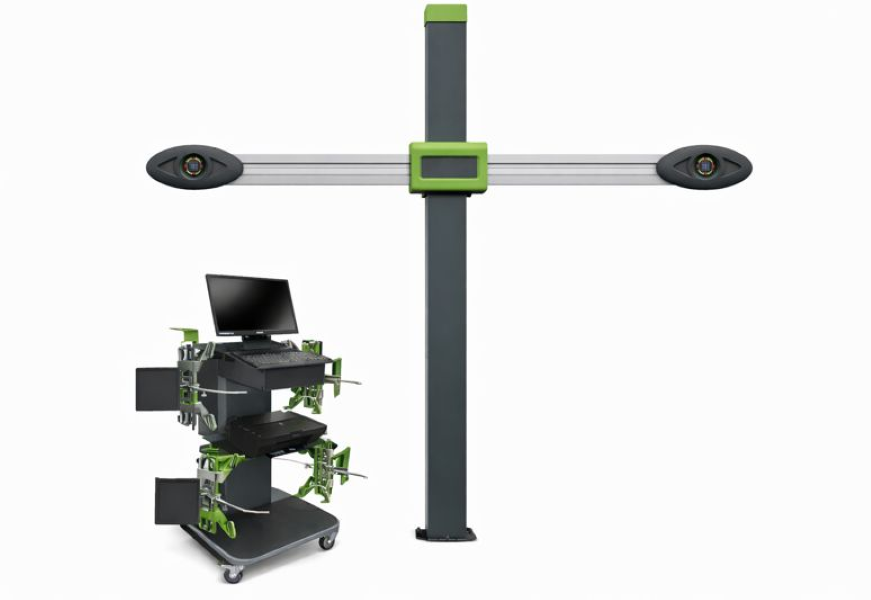 Un système de capteurs de mouvement avec une structure verticale verte et grise et deux capteurs sur chaque extrémité, associé à un poste informatique avec plusieurs écrans et composants électroniques. Utilisé probablement pour la détection de mouvement ou la mesure de vitesse.