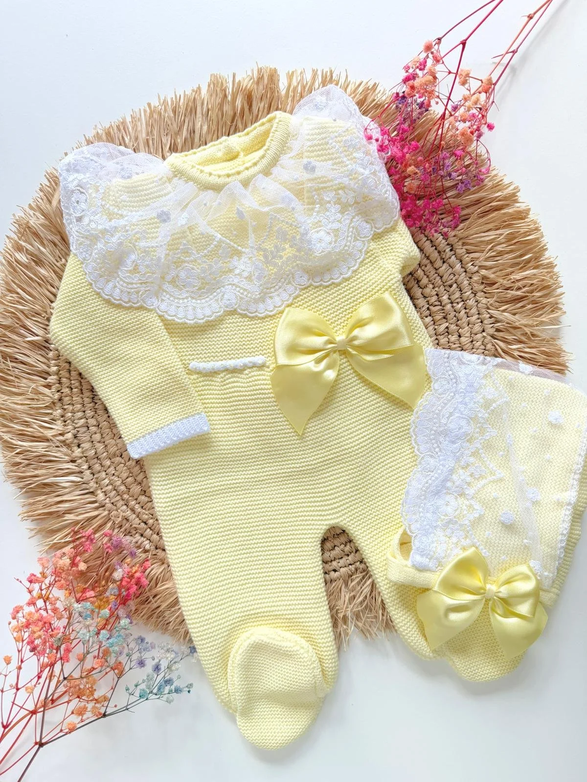 Deluxe Hand-Knitted Newborn Romper Set, includes bonnet, in soft yellow with bow detail. Perfect as a coming home outfit.
