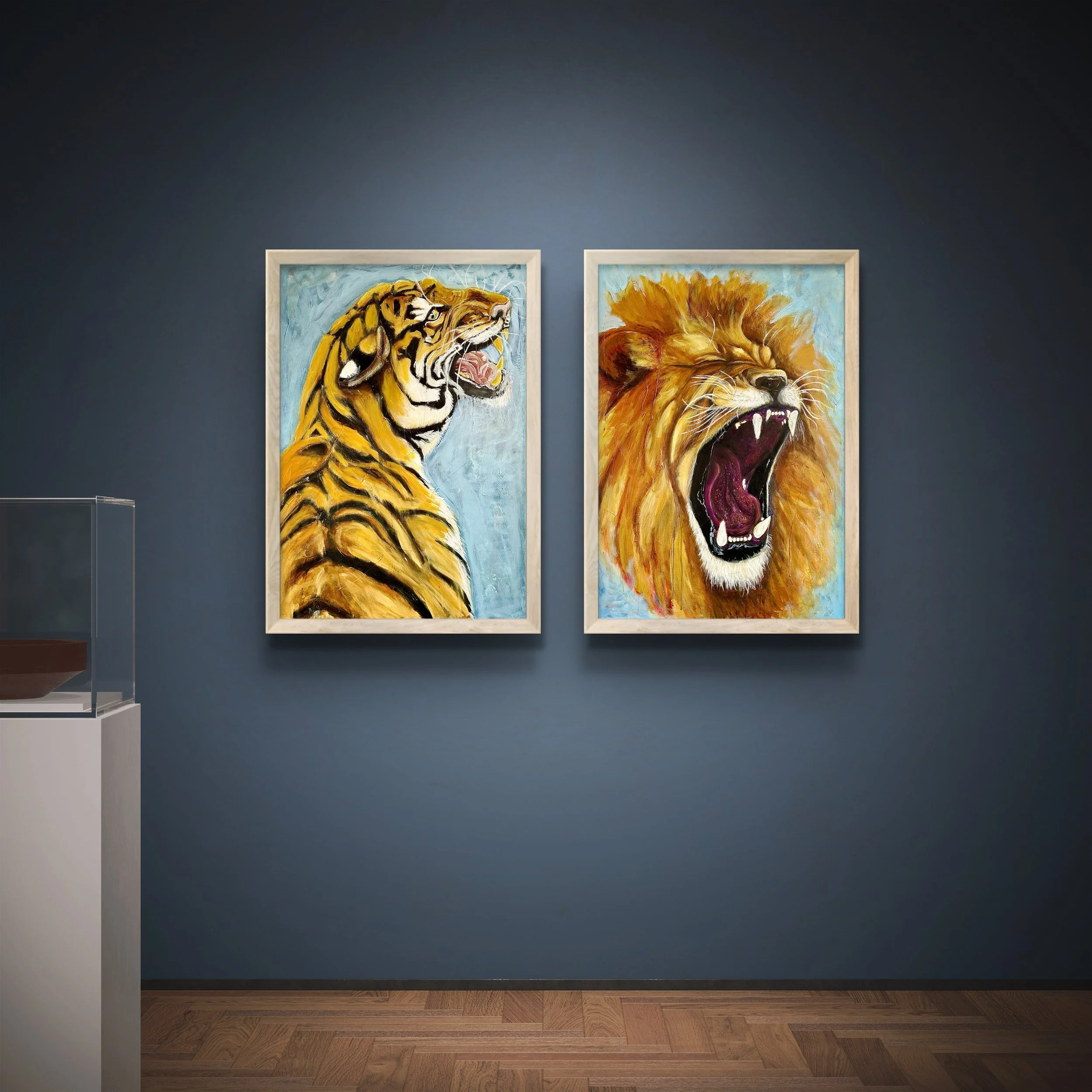 Two paintings of fierce lions on a blue wall, one with a roaring tiger and the other with a roaring lion with a mane.