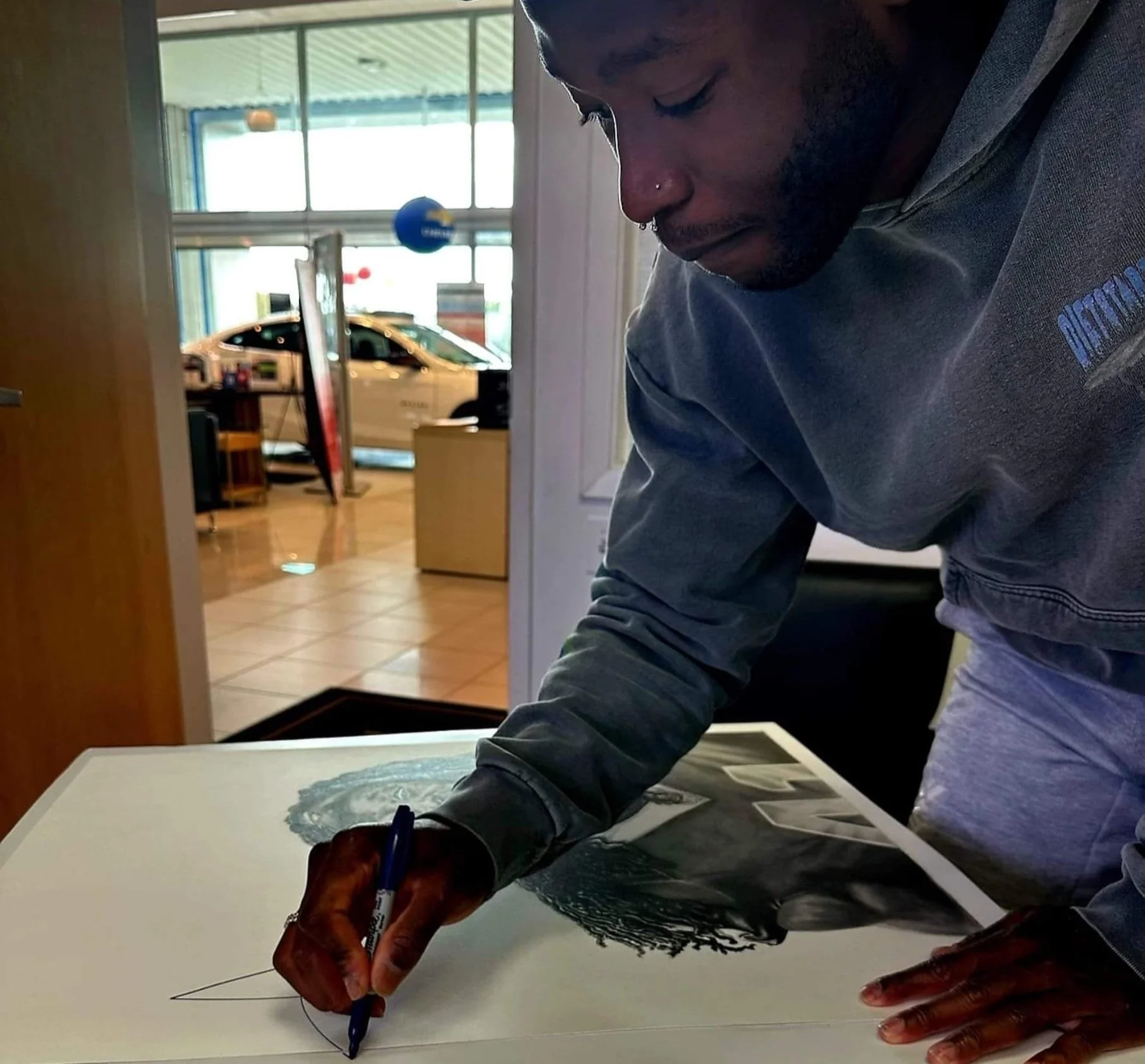 Alvin Kamara Autographing his Portrait