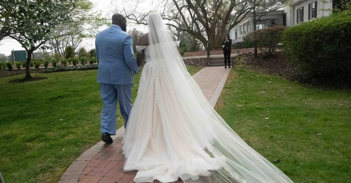 Stunning bridal entrance featuring a long flowing veil and elegant gown train, adding movement, grandeur, and classic romance to the wedding ceremony.