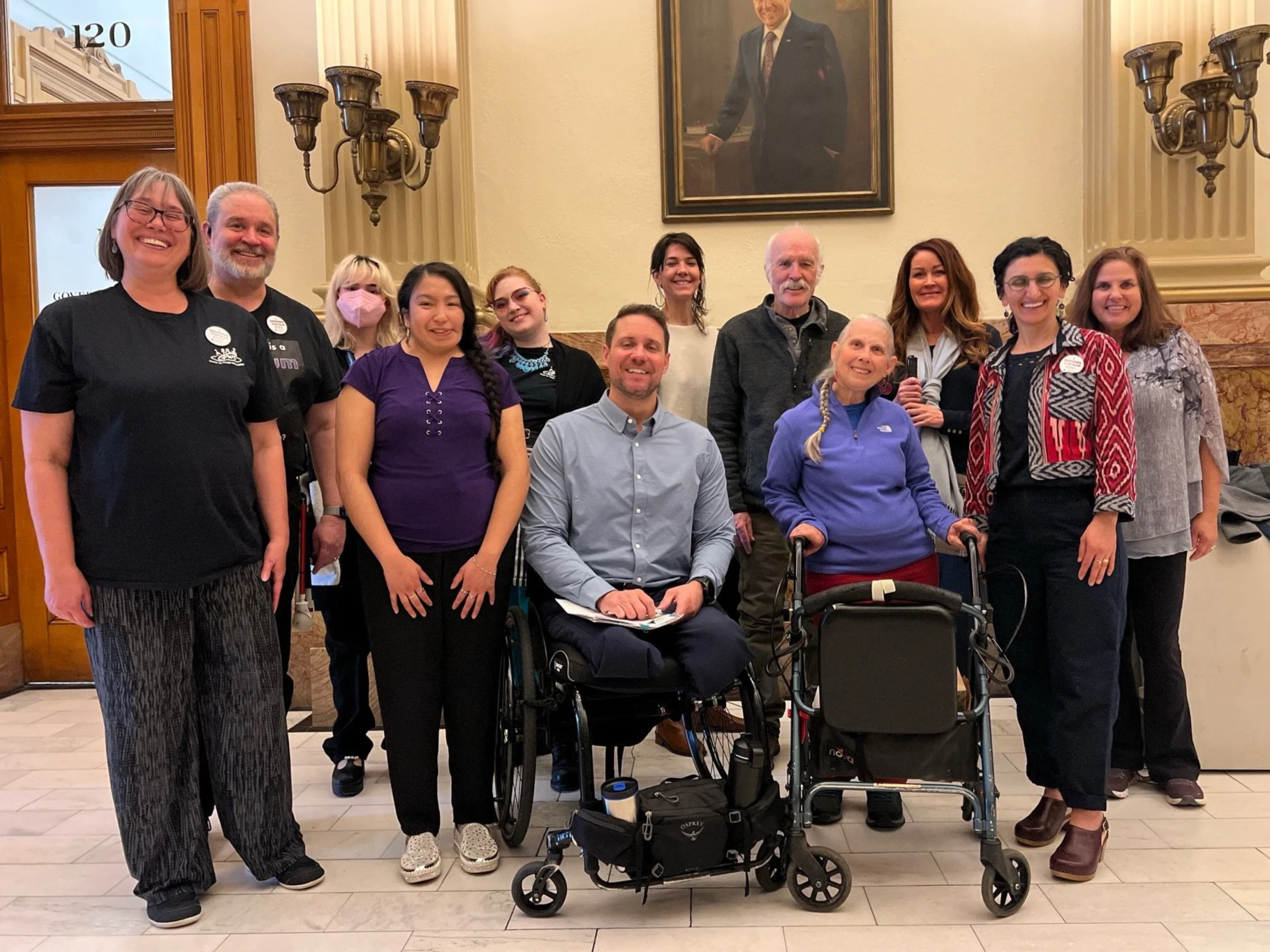 CPWD staff, board members, and consumers stand together in the Colorado State Capitol building during Disability Rights Advocacy Day in March, 2025.