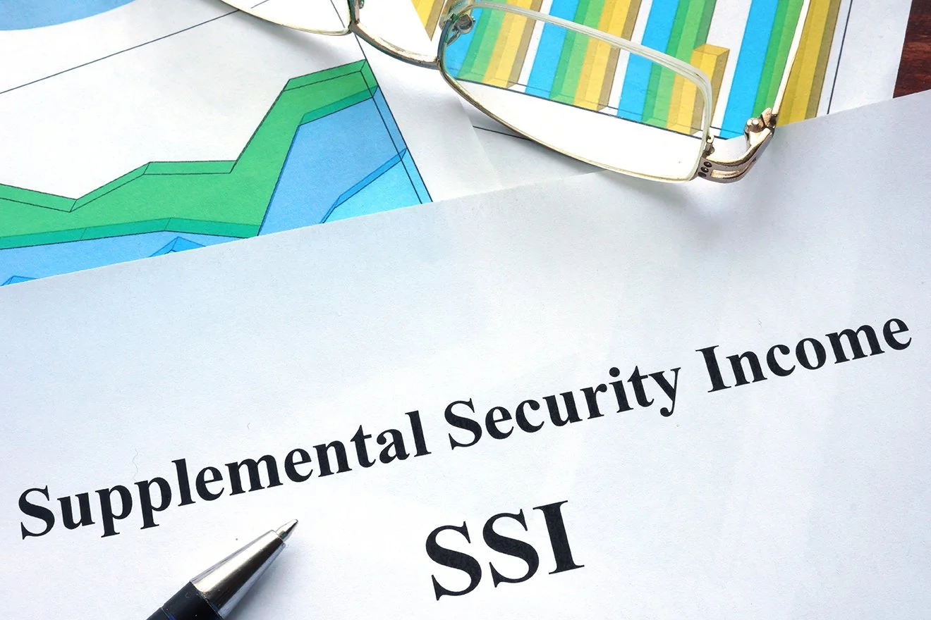 Image: A paper has “Supplemental Security Income, SSI” printed on it. A pen sits below the words.