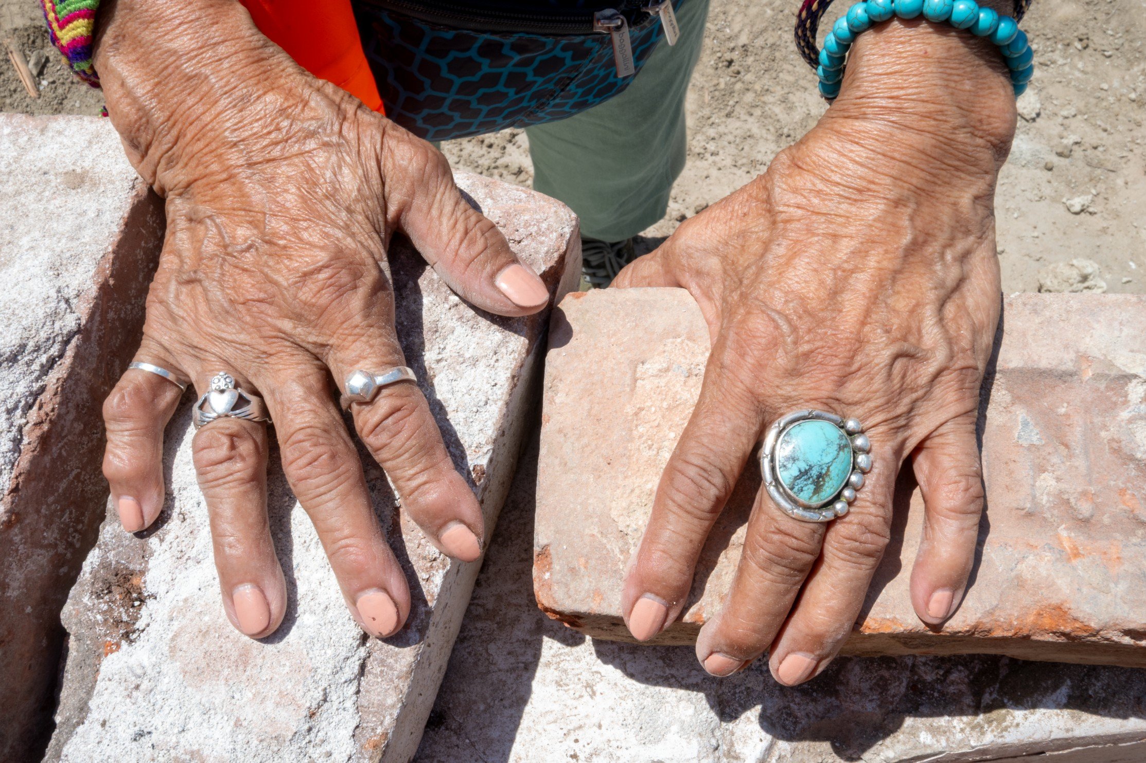 Ofelia Esparza holding Simon bricks during SHG’s building renovation process