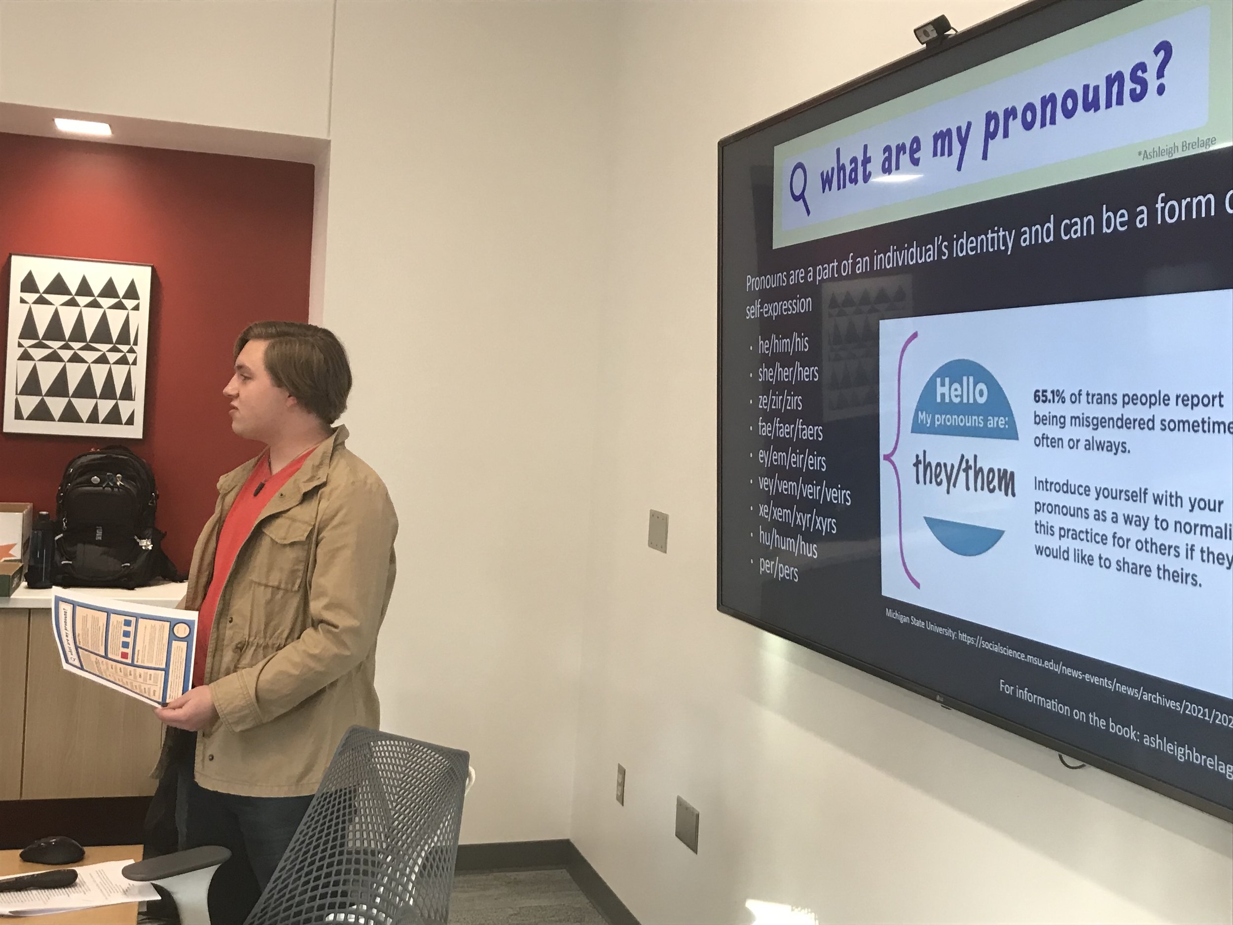Rose Hulman Institute of Technology utilizes a printed copy of the pronoun poster during a training on pronoun usage.
