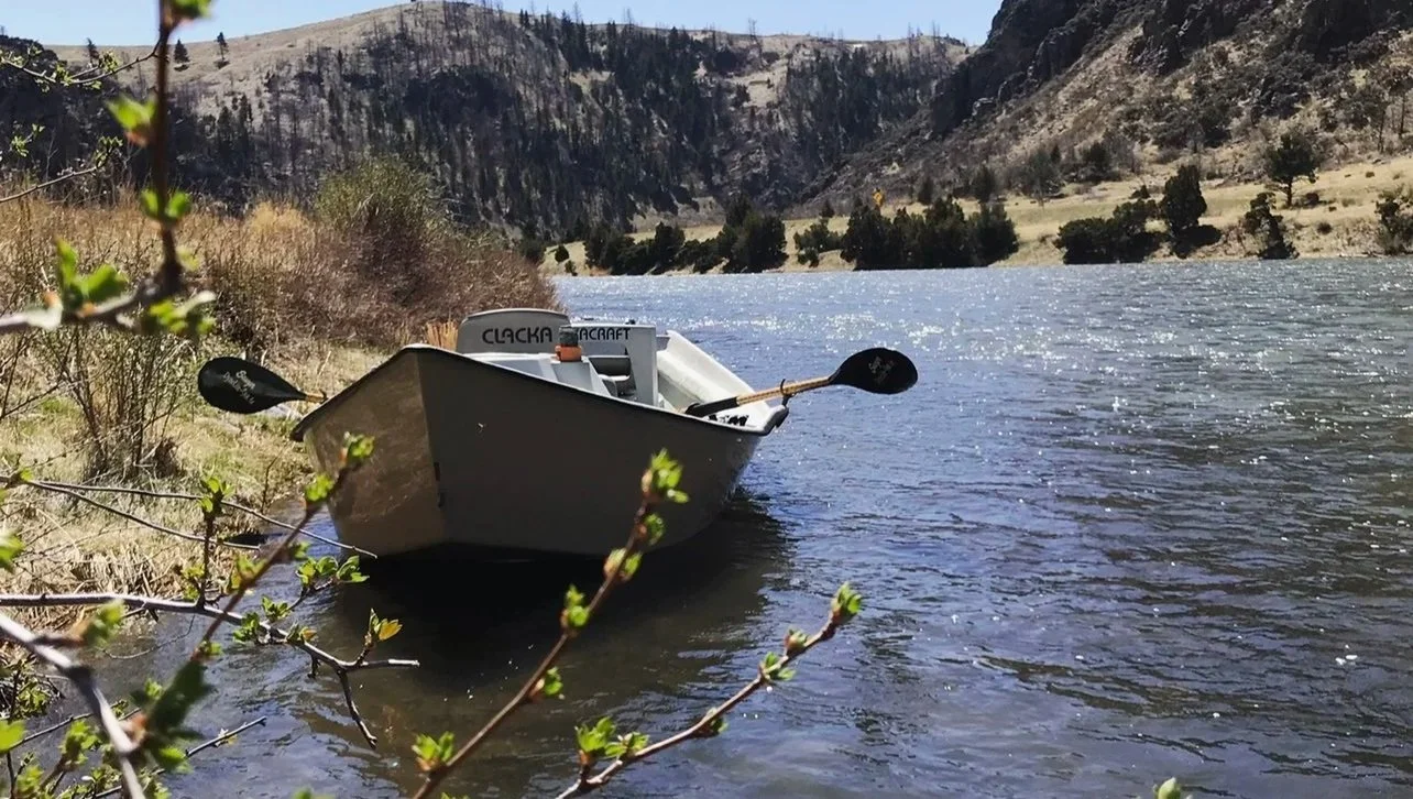 driftboat on anchored on the madison river during the mothers day caddis hatch