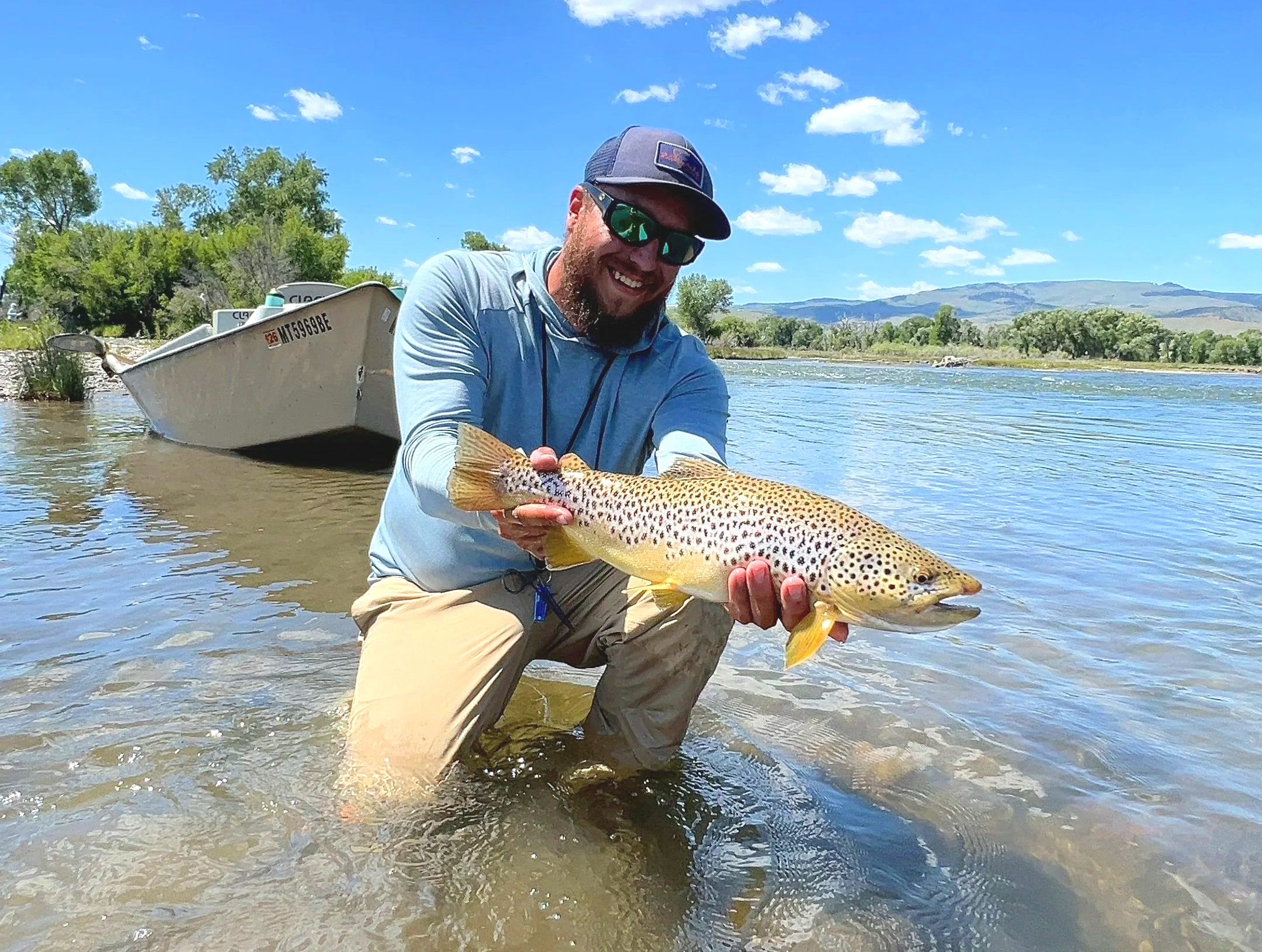 angler holding a big brown trout caught on a salmonfly on the upper madison river