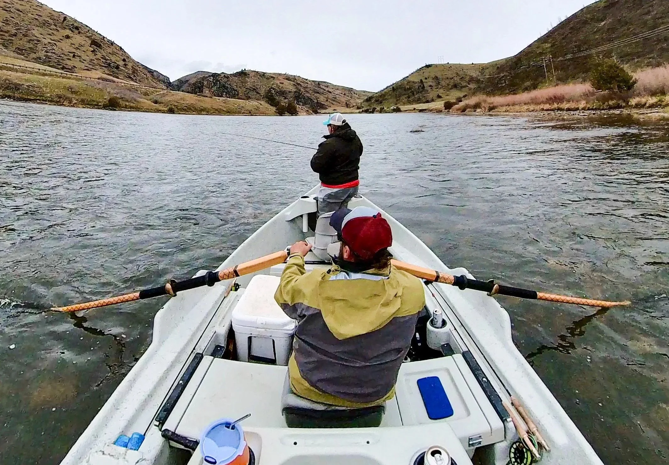 guide and angler fly fishing the lower madison river in spring during the mothers day caddis hatch
