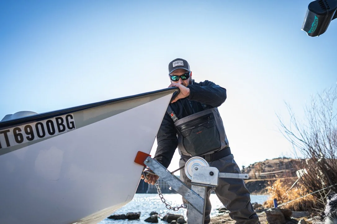 fishing guide launching a boat on a river