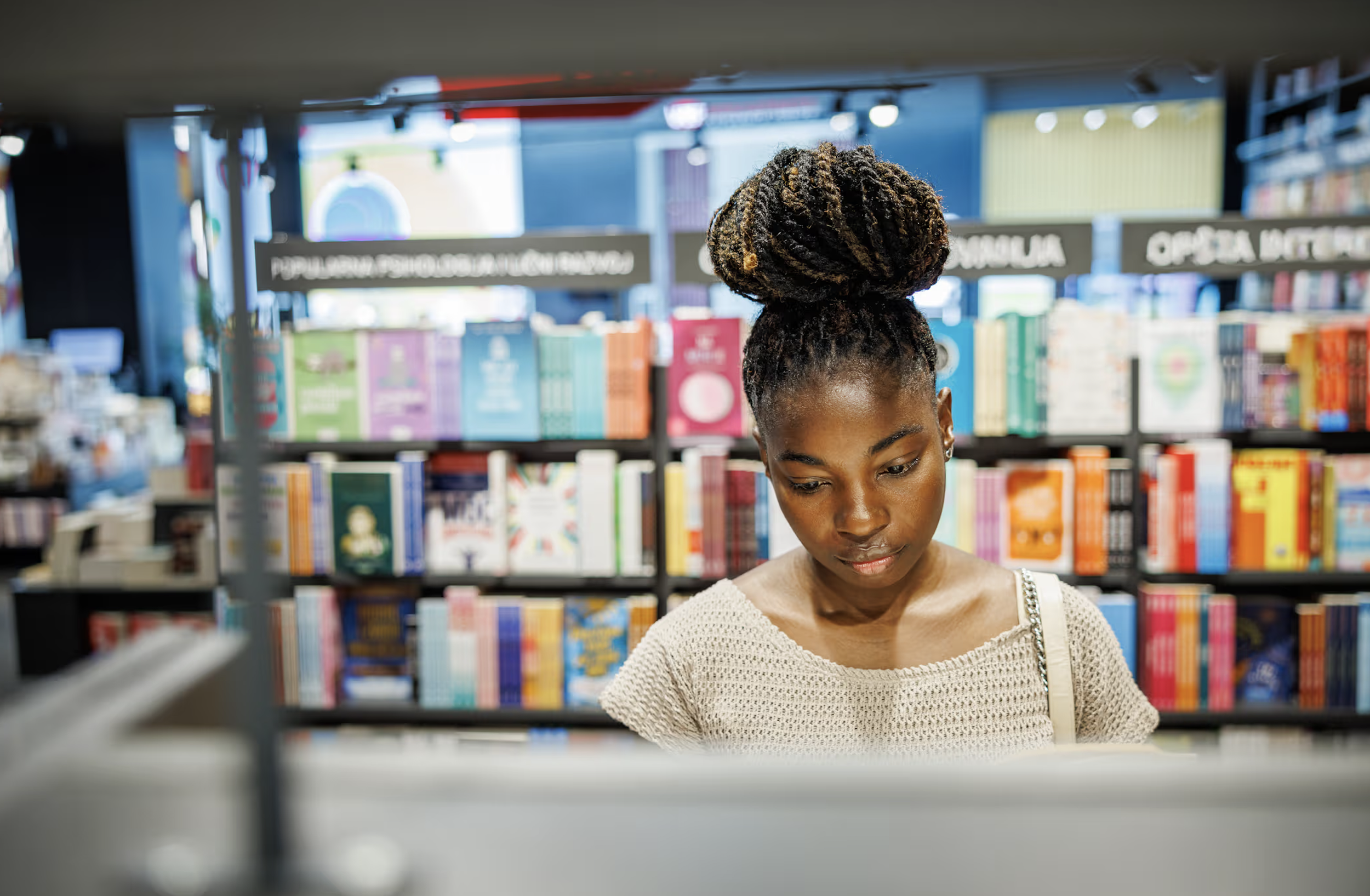 Picture of a Black woman looking at books in a bookstore