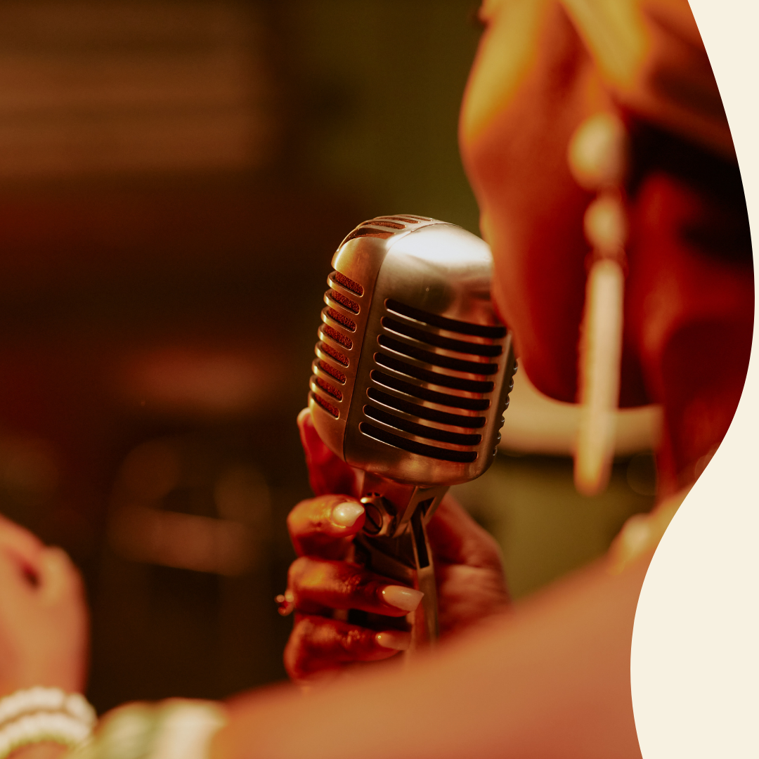 Picture of a Black woman holding a microphone