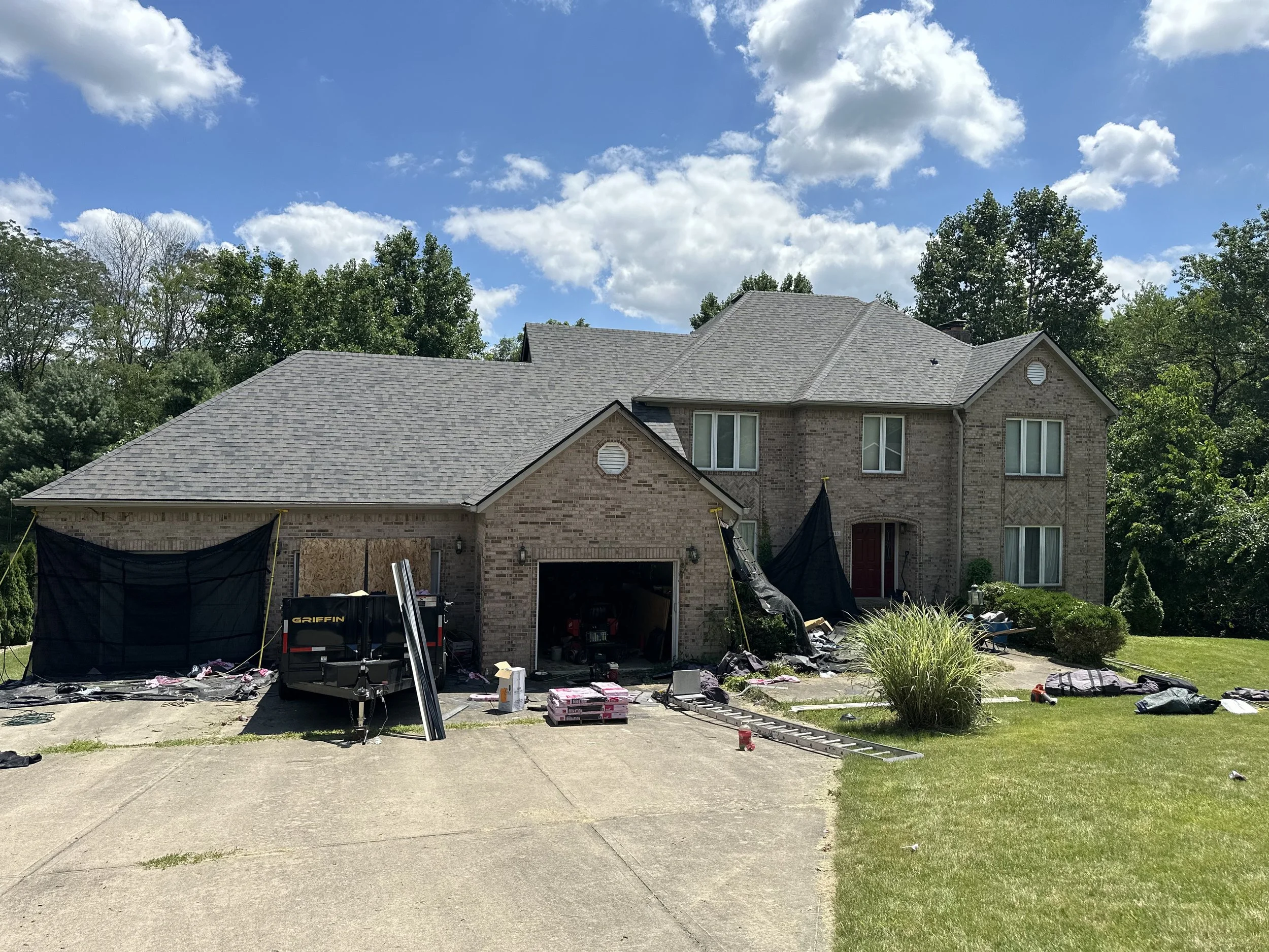 Oranssi technician working on a roof project