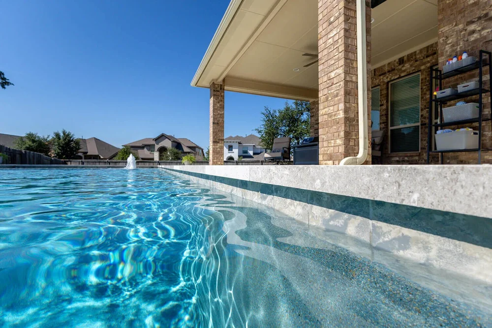 Pool with fountain and covered patio — Central Texas