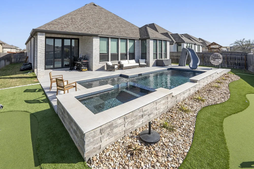 Pool with slide and tiled waterfall — Austin TX