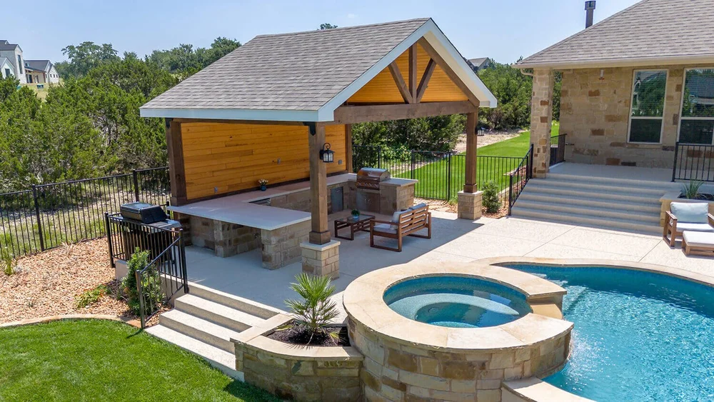 Pool with spa and outdoor kitchen area
