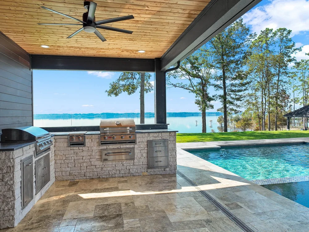 Aerial view outdoor kitchen and pool with lake views