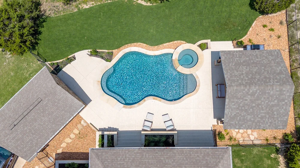 Freeform pool with spa aerial view — Central Texas