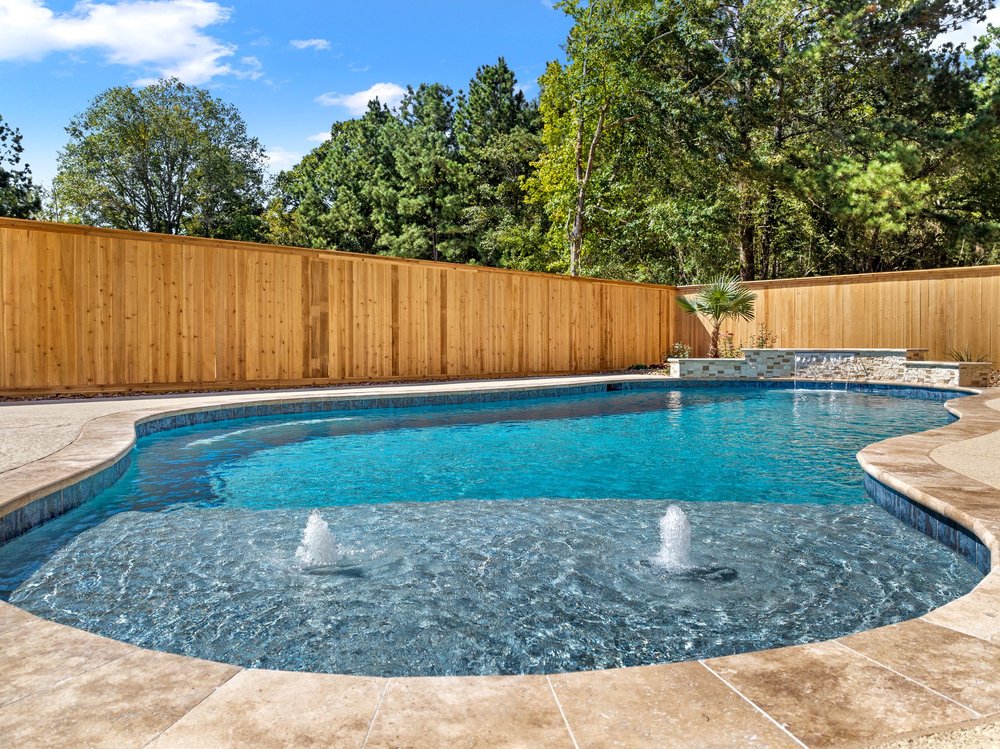 Pool with waterfall and stone deck — Austin TX