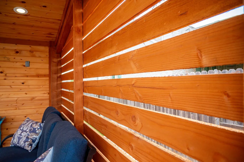Wooden slatted privacy fence with outdoor lounge area