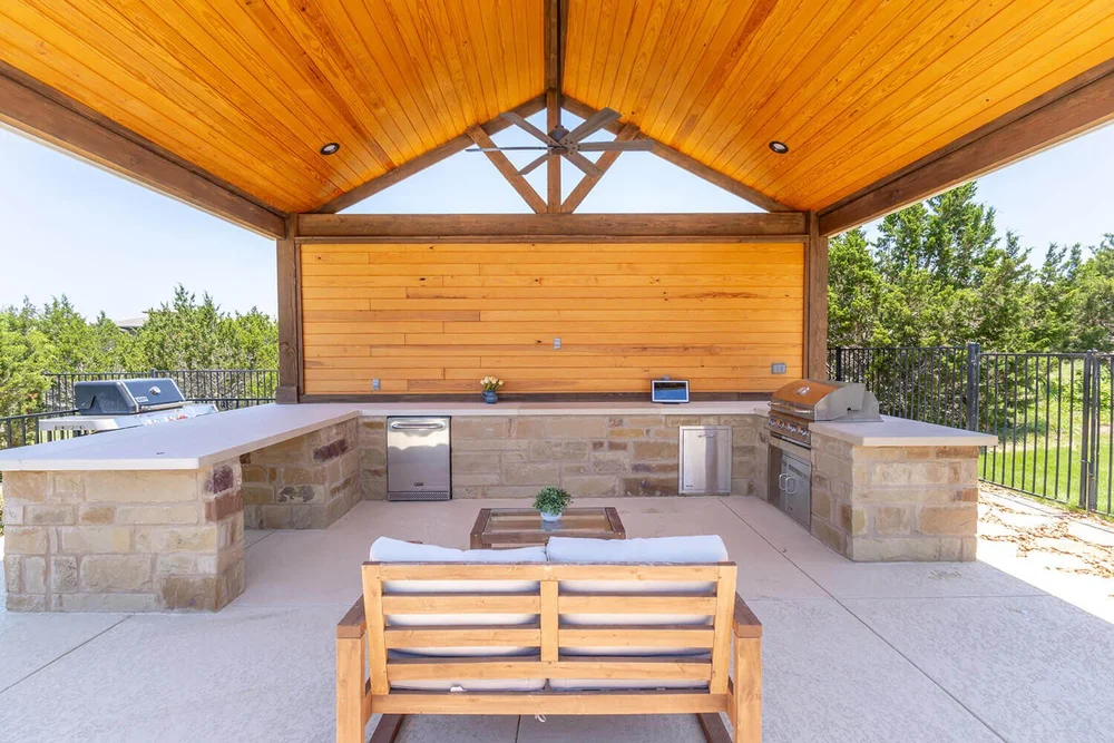 Outdoor kitchen with stone countertops and built-in grill — Central Texas
