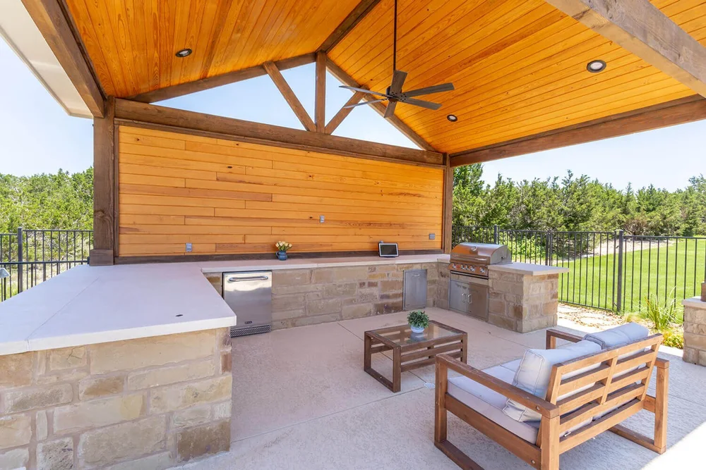 Covered patio with outdoor kitchen and ceiling fan