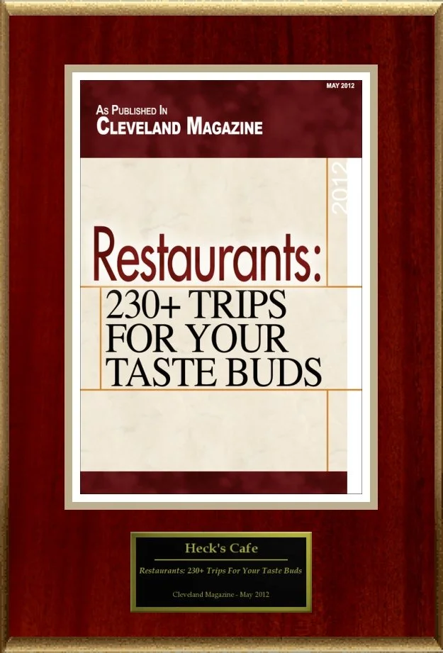 Plaque displaying a Cleveland Magazine cover from May 2012 featuring "Restaurants: 230+ Trips for Your Taste Buds." Below is a plaque label for Heck's Cafe.