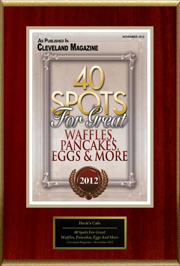 Plaque displaying an award titled "40 Spots For Great Waffles, Pancakes, Eggs & More" from Cleveland Magazine, dated November 2012, featuring Heck's Cafe.