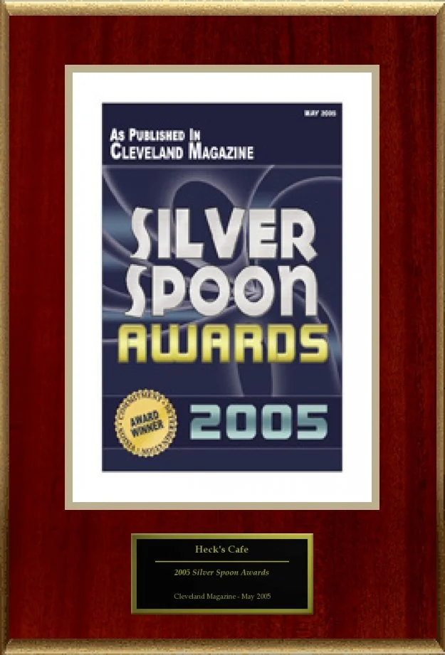 Plaque displaying a "Silver Spoon Awards 2005" certificate, published by Cleveland Magazine. The plaque indicates "Heck’s Cafe" as an award recipient in May 2005.