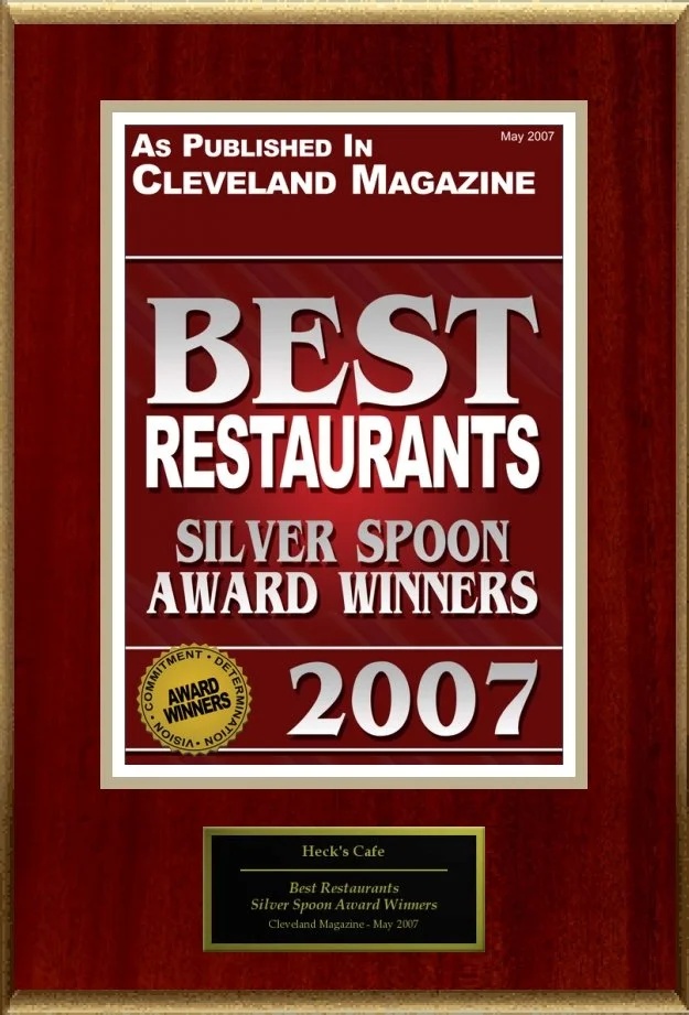 Plaque for Heck's Cafe, awarded "Best Restaurants Silver Spoon Award Winners 2007" by Cleveland Magazine, featuring a prominent red design with gold seal.