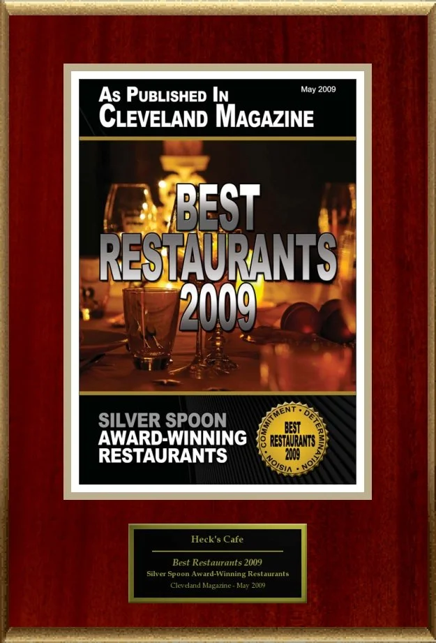 Plaque for "Best Restaurants 2009" from Cleveland Magazine awarded to Heck's Cafe, featuring Silver Spoon award badge and dining imagery.