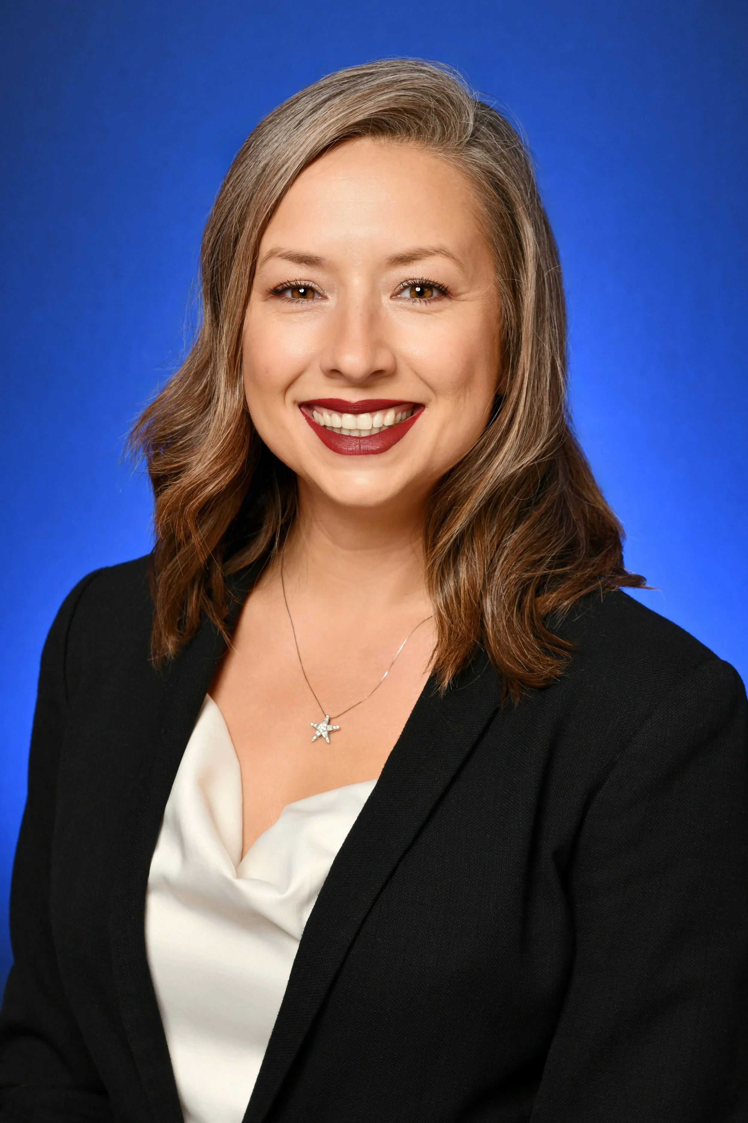 Woman with red lipstick and black business jacket