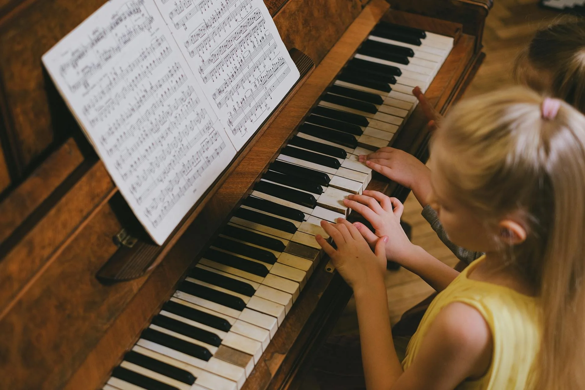 Young student learning to play the piano