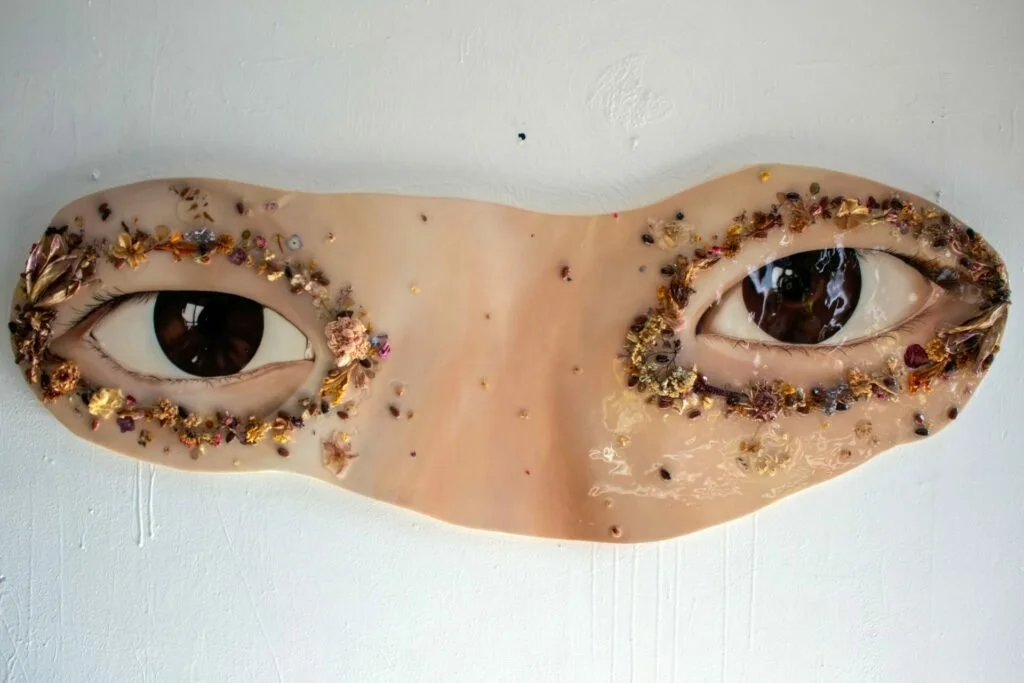 Eyes as guardians of memory. Framed in petals and resin, they invite us to witness beauty, grief, and resilience all at once.